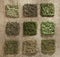 Nine dried herb piles on jute hessian backdrop