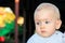 A nine-month-old boy with blond hair and blue eyes. A beautiful nine-year-old baby. Blurred background. Close up