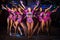 Nine showgirls in purple costumes with raised hands perform