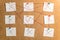 Nine white stickers for notes with x and v marks rewound on a ca