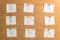 Nine white stickers for notes with x and v marks rewound on a ca