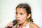 Nine year old girl singing with microphone