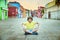 A nine years old boy is sitting on street of Burano
