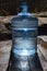 A nineteen-liter water bottle on a wooden walkway