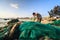 Ninh Thuan, Vietnam - Feb 22, 2014 : Fishermen is removing unusable fishing net at My Hiep beach in the afternoon