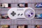 A Nintendo SNES Controller Floating Over NES Cartridges