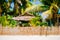 Nipa hot cottage over the fence with white sand beach on the tropical island