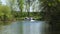 NISSWA, MN - 27 JUL 2022: Pontoon boat rounds corner on a Minnesota river.