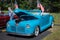 NISSWA, MN - 30 JUL 2022: Vivid sky blue antique vintage convertible automobile with the top down and an open hood, at a car sho