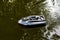 Nitaure, Latvia â€“ June 05, 2021: gps bait boat for fishing with carp bait floating on water