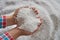 Nitrogen fertilizers or urea fertilizer in farmer hand. blur white fertilizer background.