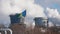 NIZHNEKAMSK, RUSSIA - March, 2018: pipes of large chemical and power plant with emissions, flag of the city in the