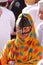 NIZWA, OMAN - FEBRUARY 3, 2012: Portrait of a bedouin Omani woman traditionally dressed attending the Goat Market in Nizwa