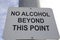 No alcohol beyond this point -signage on a metal pole