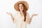 No big deal. Portrait of carefree optimistic charming kind female with ginger hair and freckles in cute straw hat and