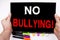 No Bullying text written on tablet, computer in the office with marker, pen, stationery. Business concept for Bullies Prevention A