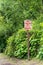 No camping or overnight parking sign, red lettering on rural road.