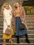 No cares. european winter. girls warm coat on stairs. faux fur coat fashion. stylish business ladies leather bag