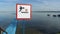 No Diving sign at beach, lake Naroch, Belarus. Warning sign of shallow water. Warning notice sign do not jump in water