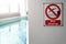 No diving sign at the poolside warning on blurred swimming pool