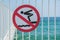 No diving into the water sign, prohibition, warning symbol, forbidding sign on a fence in a bridge near the sea