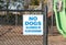 No Dogs Allowed In Playground sign on the fence of a playground