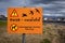 No dogs running free allowed, bird conservation area signpost in icelandic language.