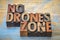 No drones zone sign or banner in wood type