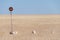 No entry or passage prohibited sign in the middle of the Namib Desert isolated in front of blue sky