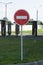 No-entry road sign. Red round sign on a pillar with white bricks.