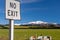 No Exit sign in a rural landscape with mountains a blue skybackground