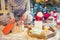 No face young woman opening Christmas present box with blurred wooden tray with festive breakfast. Cocoa and cookies for Santa.