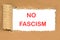 no fascism the phrase written on a piece of cardboard