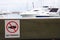 No fishing warning sign on wooden bench block for sitting in pie