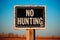 No Hunting Sign on Wooden Post