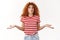 No idea sorry. Perplexed awkward redhead curly woman summer striped t-shirt shrugging hands sideways pursing lips