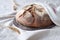 No knead handmade loaf on cutting board on textile with linen towel, spelt ears. German Bauernbrot means Farmers Bread