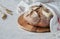 No knead handmade loaf on cutting board on textile with linen towel, spelt ears. German Bauernbrot means Farmers Bread