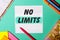 NO LIMITS written on a turquoise background near bright stickers, notepads and markers