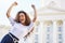 No medicine cures what happiness cannot. a young woman celebrating outside.