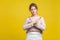 No more, this is the end. Portrait of serious stubborn young woman with fair hair in casual beige blouse, isolated on yellow