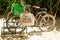 No More Plastic eco bag on bicycle basket parked on sandy tropical forest