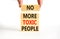 No more toxic people symbol. Concept words No more toxic people on wooden blocks on a beautiful white table white background.