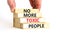 No more toxic people symbol. Concept words No more toxic people on wooden blocks on a beautiful white table white background.