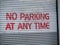 No parking at any time spray painted warning sign on garage door