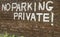 No parking private painted in large white capital letters in a b