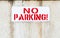 No parking sign. Private zone. Please do not leave you car here. Road up. Do not enter. Road signs. Red letters.