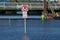 No Parking sign submerged in flood waters, showing perspective of the St Croix River flooding