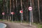 No passing road sign and arrows on winding road in the forest