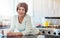 No place more relaxing than home. a mature woman enjoying a warm beverage in the kitchen at home.